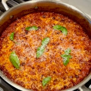 One pan baked sausage orzo topped with Parmesan and fresh basil.
