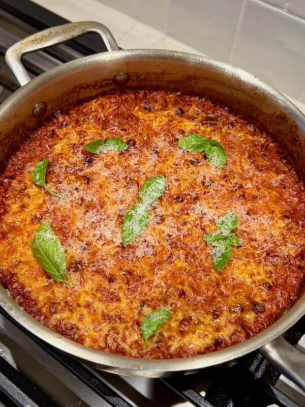 One pan baked sausage orzo topped with Parmesan and fresh basil.