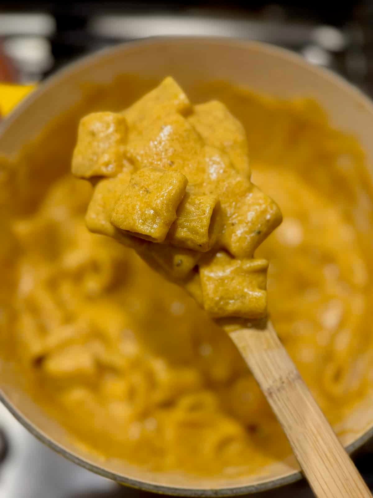 Trader Joe's copycat butternut squash mac and cheese on a wooden spoon.
