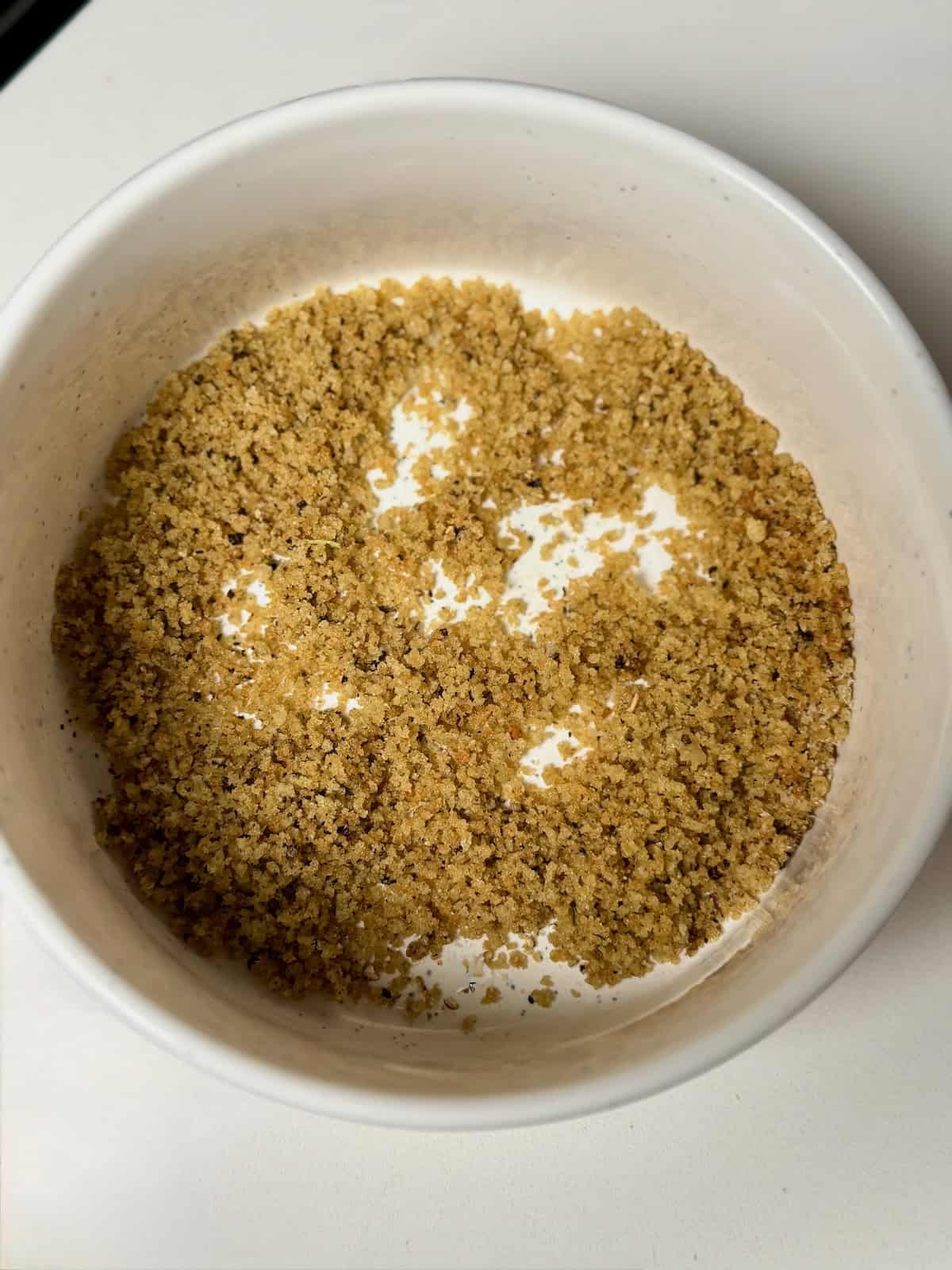 Golden brown butter breadcrumbs in a bowl ready to be used as a crispy topping.