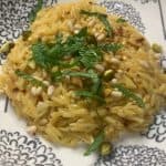 A bowl with orzo, mint, pistachios