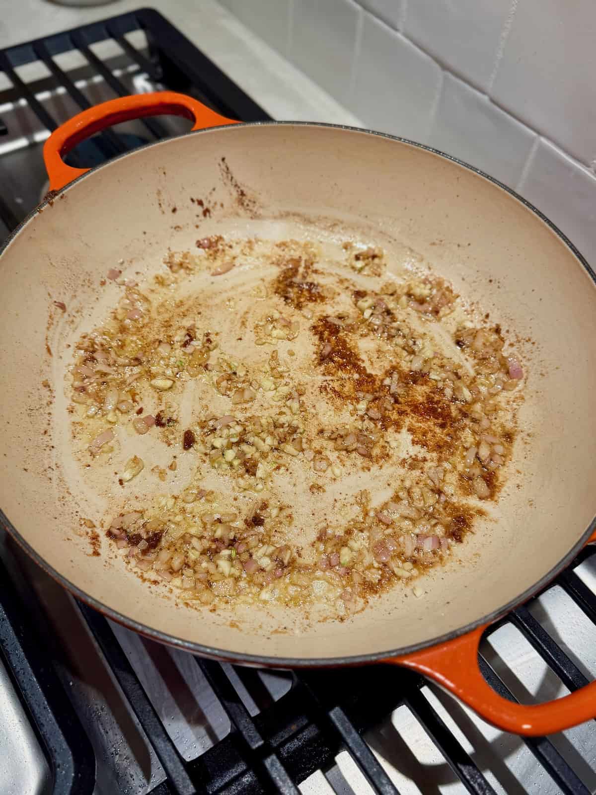 Chopped shallot and garlic sauté in the skillet with browned bits from the chicken.