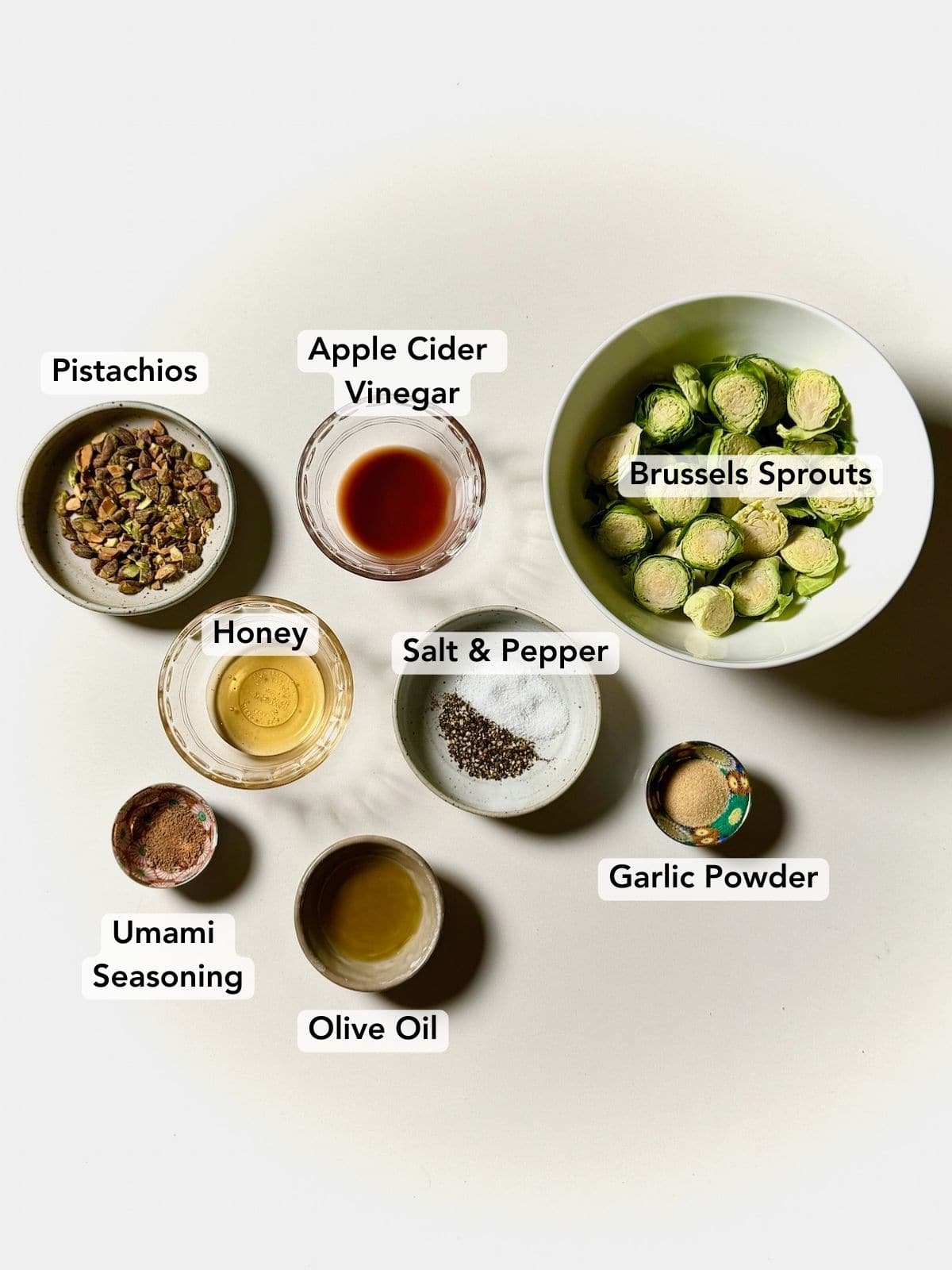 Ingredients for air fryer pistachio honey brussels sprouts labeled.