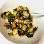 Air Fryer Pistachio Honey Brussels Sprouts served in a bowl on a spoon.
