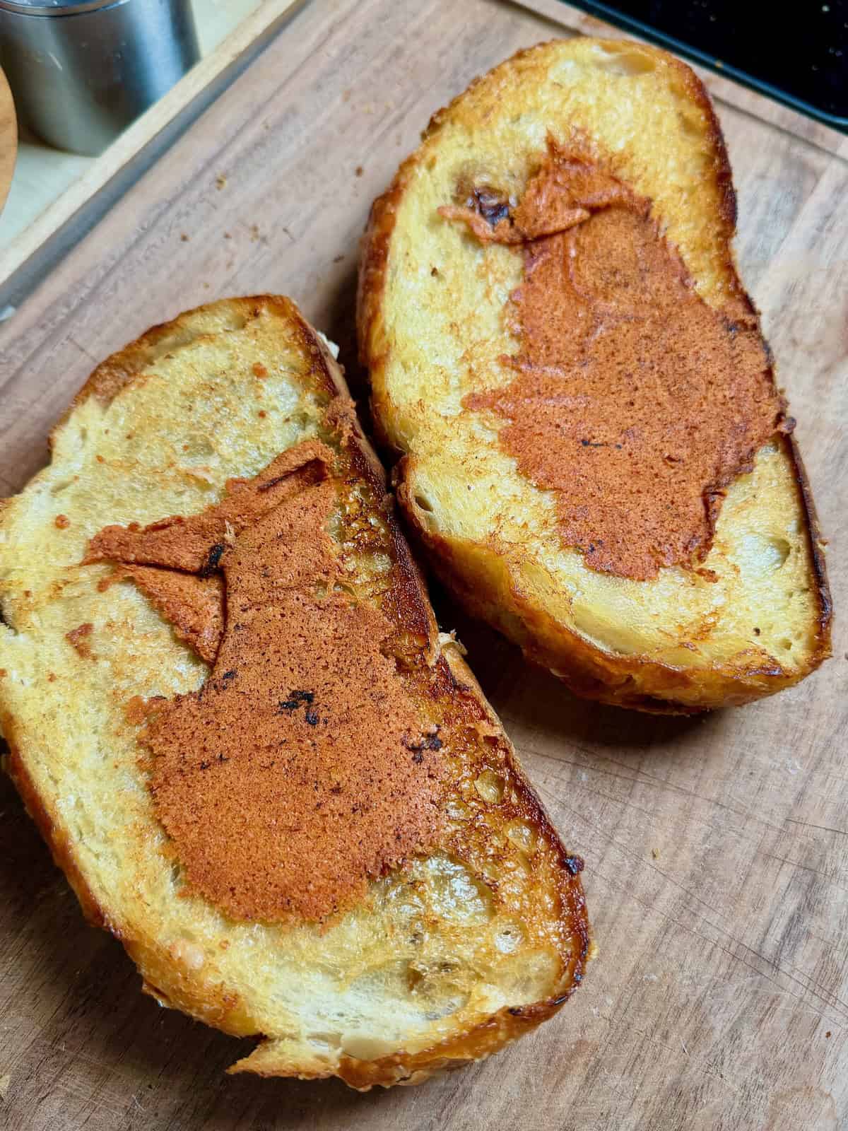 Grilled cheese sandwich toasted until golden brown on both sides with cheese crust.