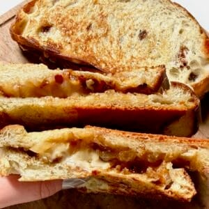 Caramelized onion grilled cheese with melted cheese and golden bread.