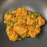 A bowl with one pan creamy tomato chicken boursin orzo.