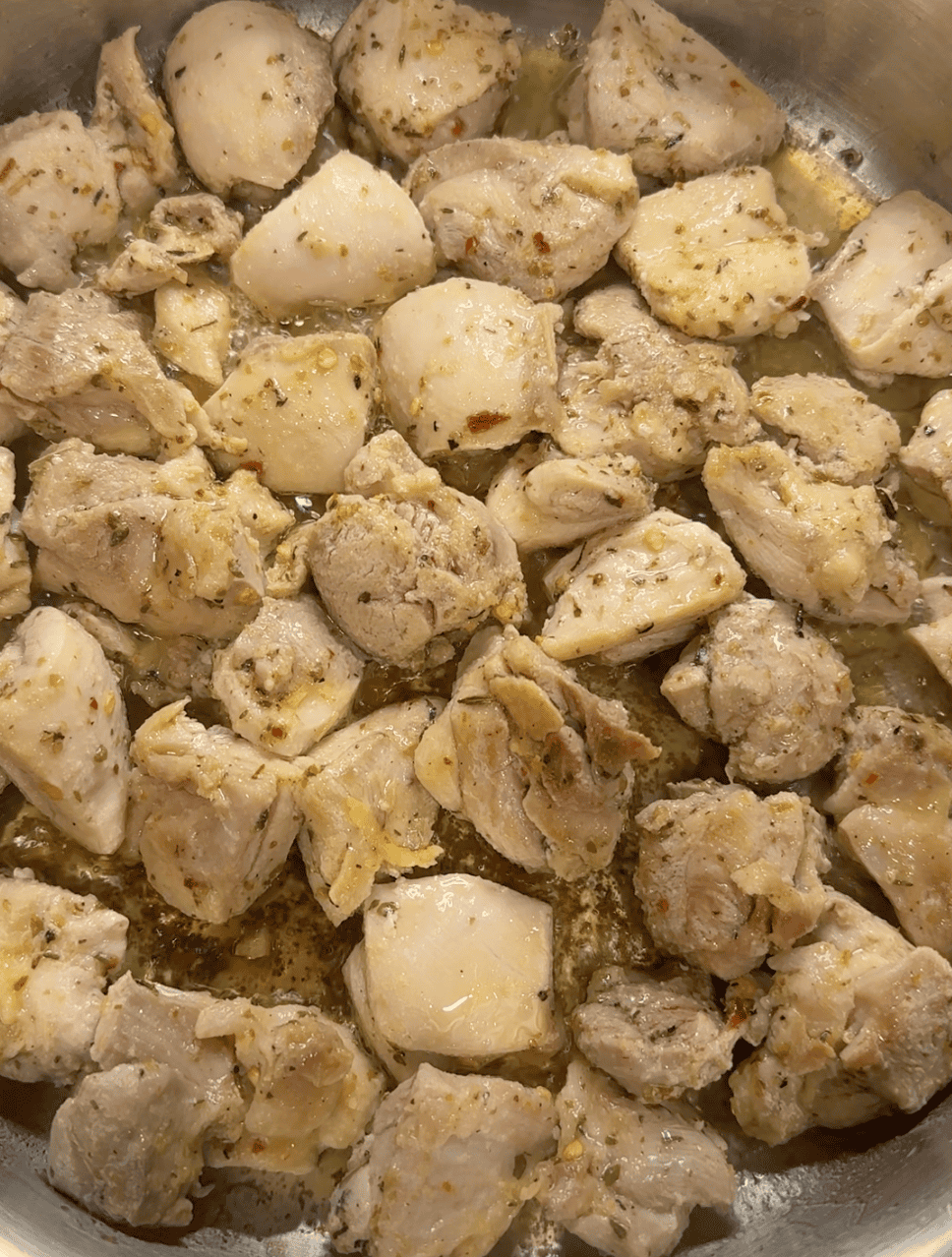 Pieces of partially cooked chicken thighs.