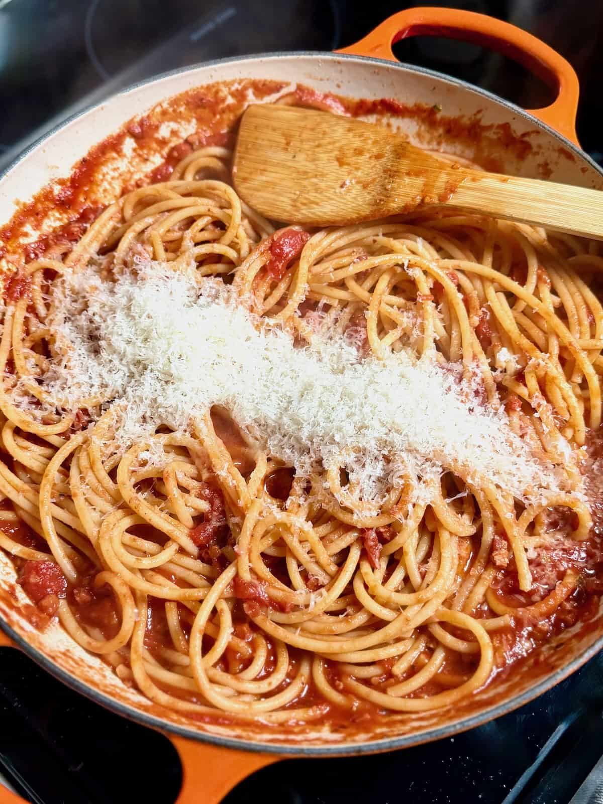 Bucatini tossed with amatriciana sauce and coated evenly.