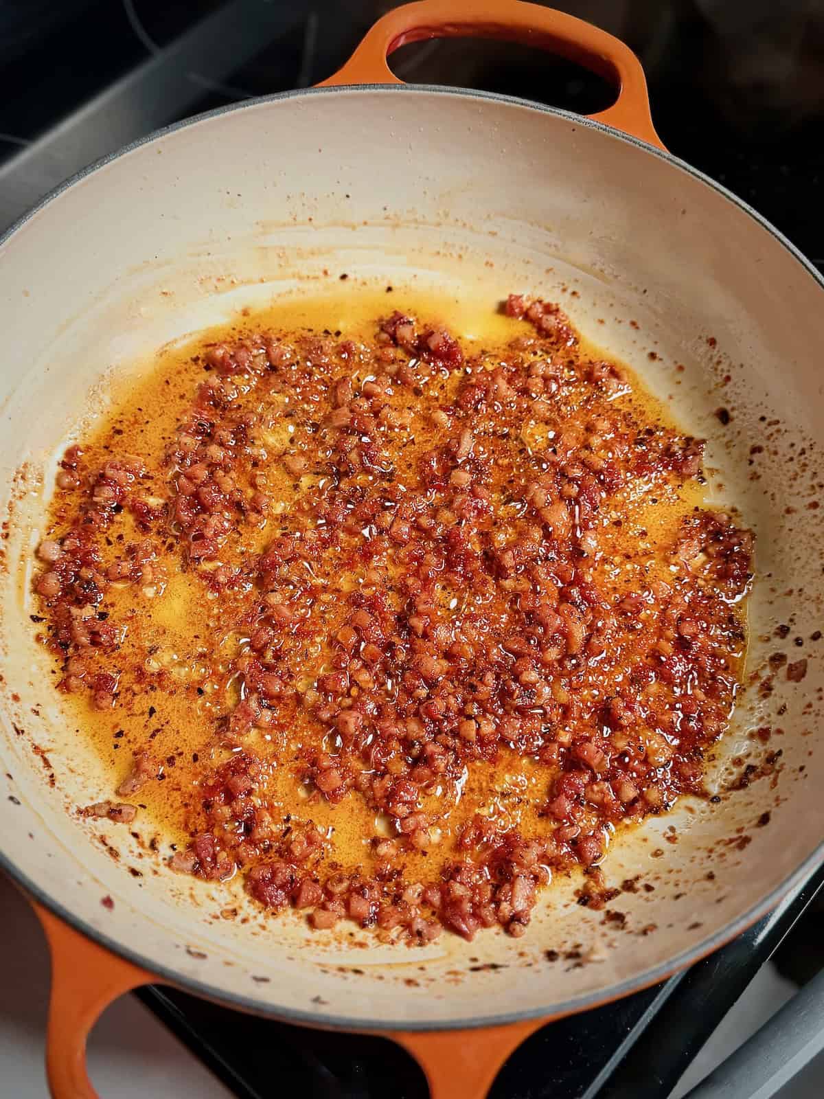 Tomato paste stirred into pancetta fat for bucatini amatriciana.