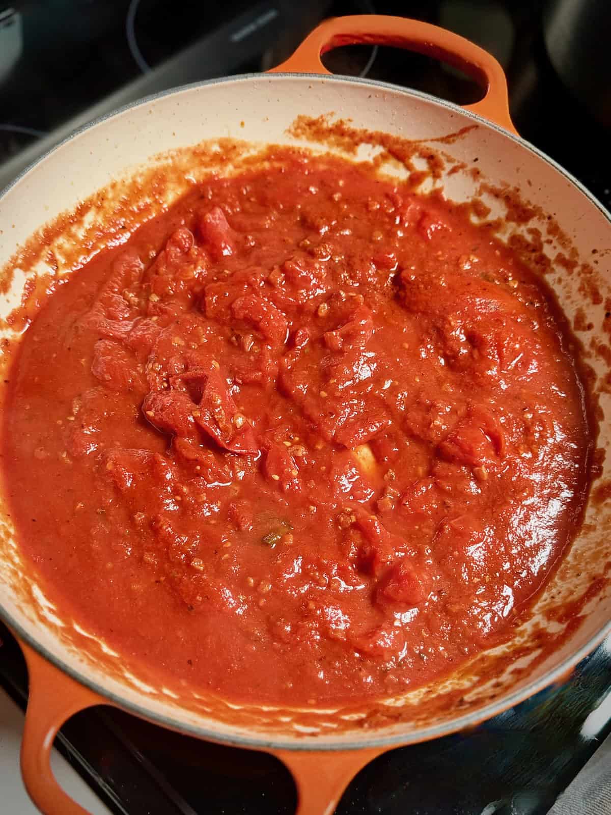 Tomato sauce simmering in a pan for bucatini amatriciana.