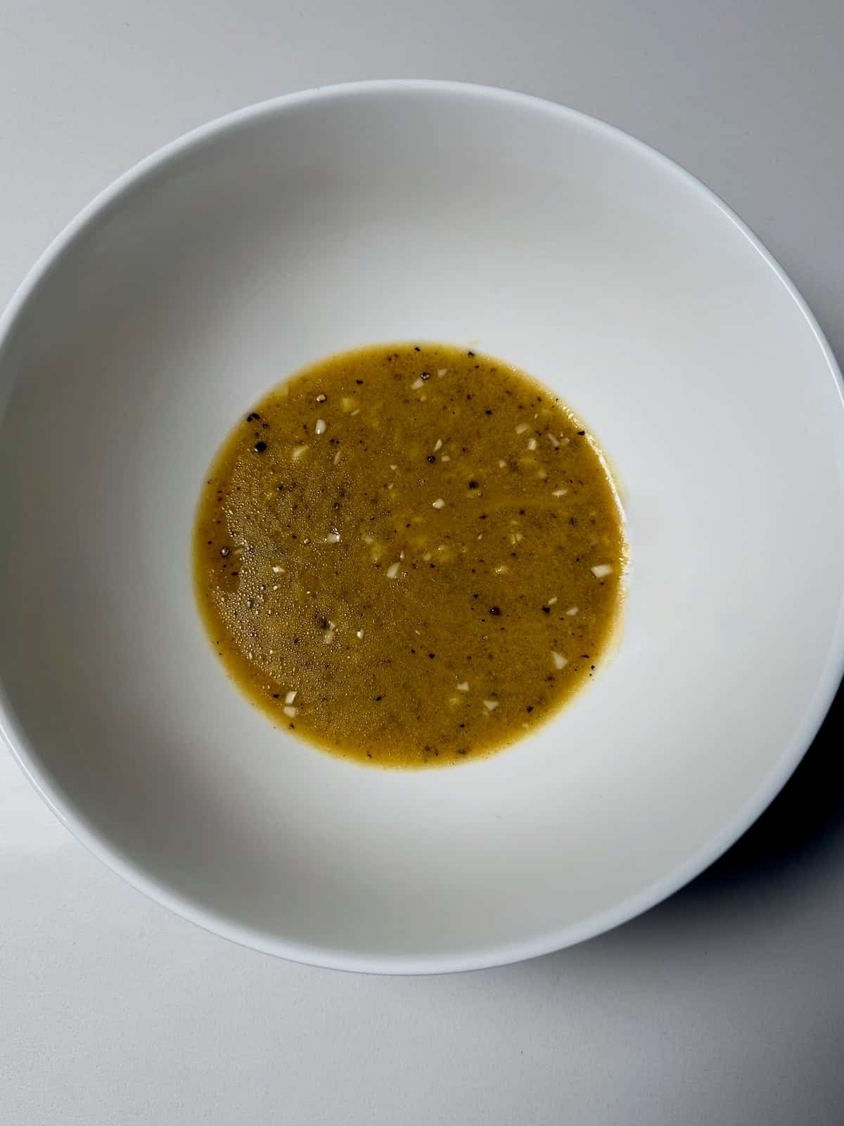 Honey Dijon sauce mixed in a bowl for foil packet salmon.