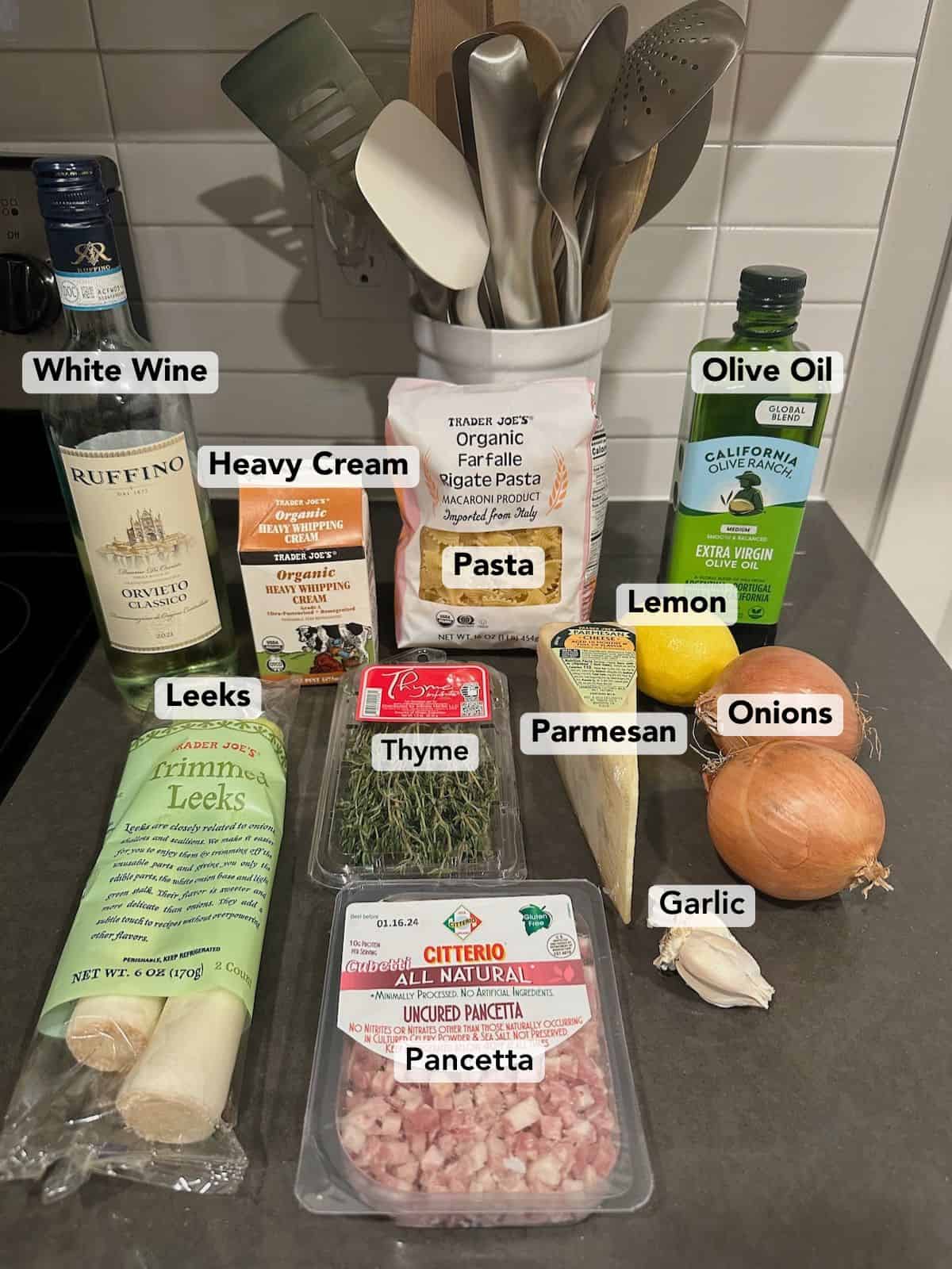 Caramelized leek and onion pasta ingredients on counter labeled.