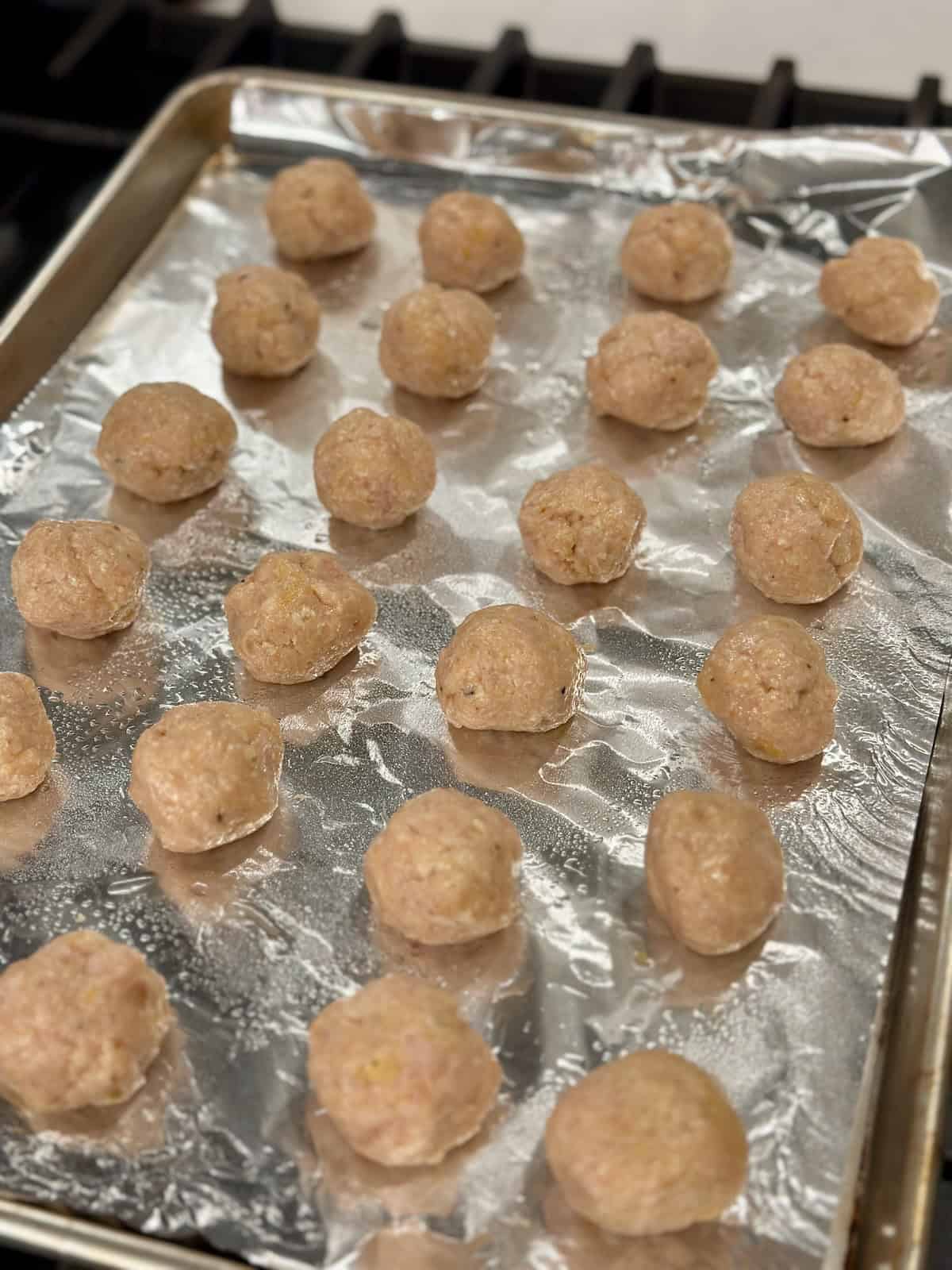Raw Chicken Meatballs on Baking Sheet