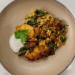 Chicken shawarma on top of orzo with yogurt sauce.