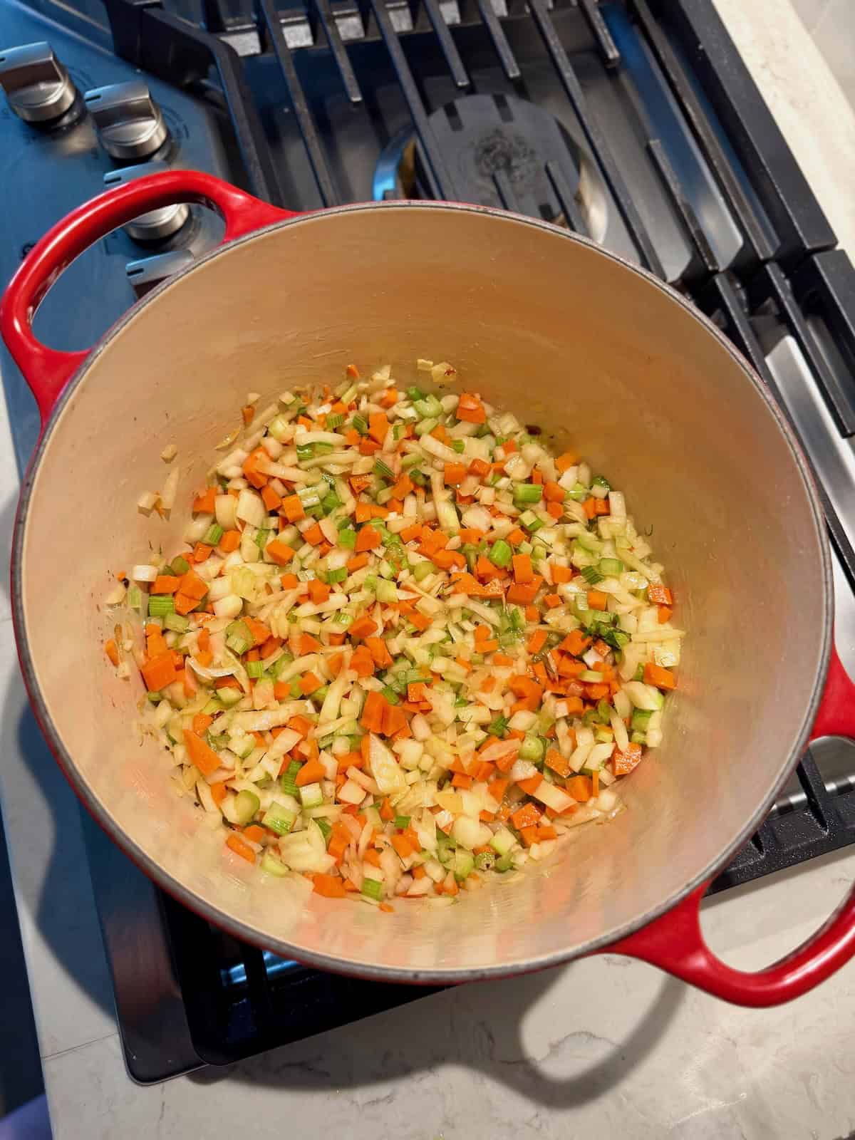 Diced onion, carrot, and celery soften together in a Dutch oven.