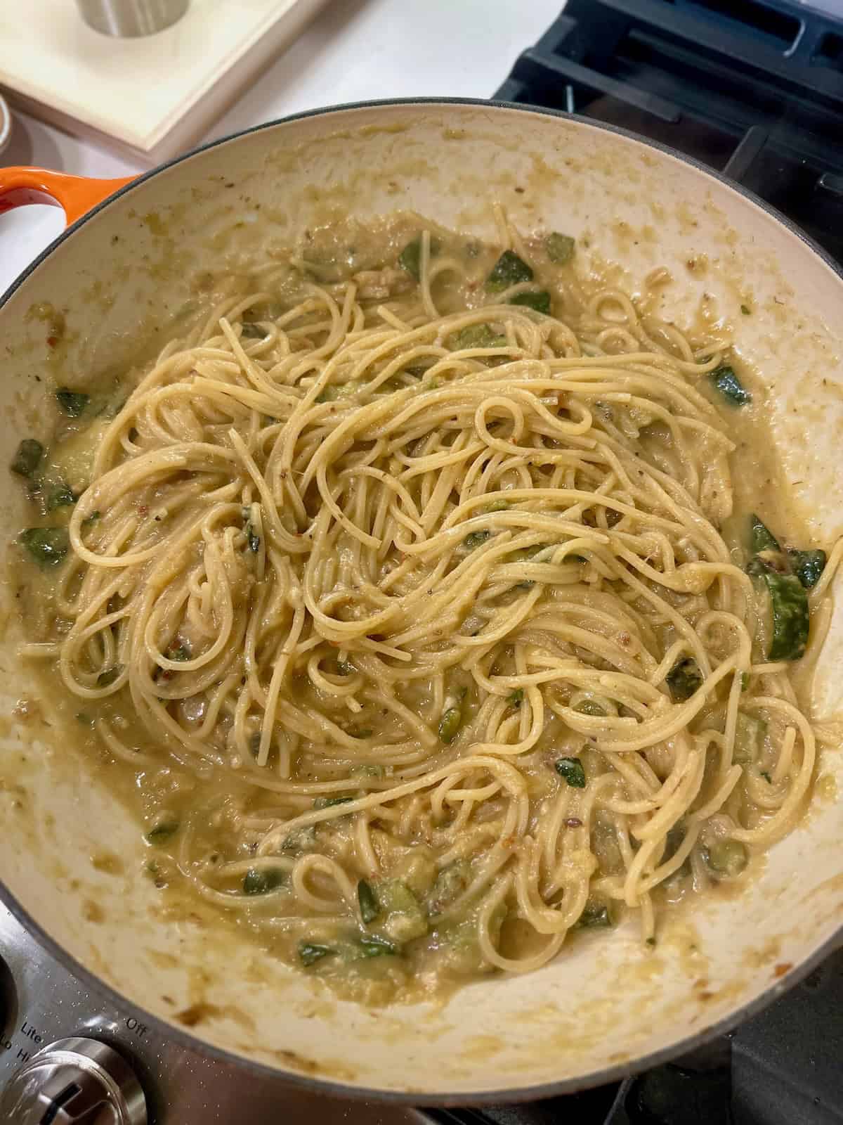 Spaghetti tossed with zucchini sauce, butter, cheese, and pasta water.