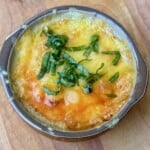 Crock with broiled cheese and basil