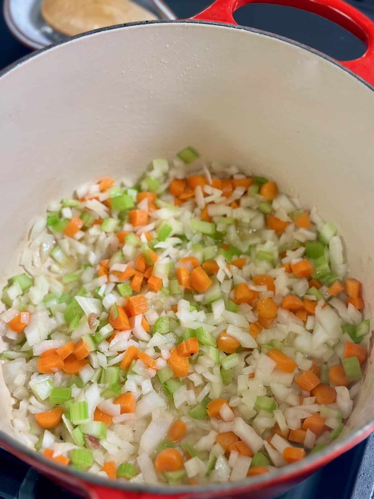 Dutch Oven with cooked onions, carrots, celery