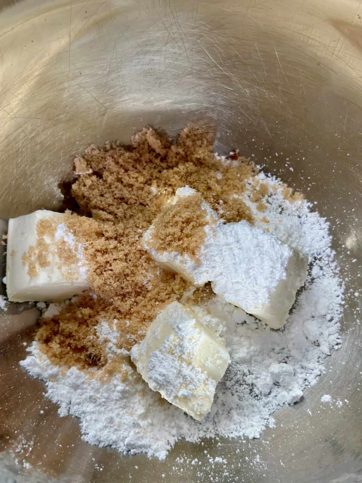 Metal bowl with cream cheese, brown sugar, and powdered sugar