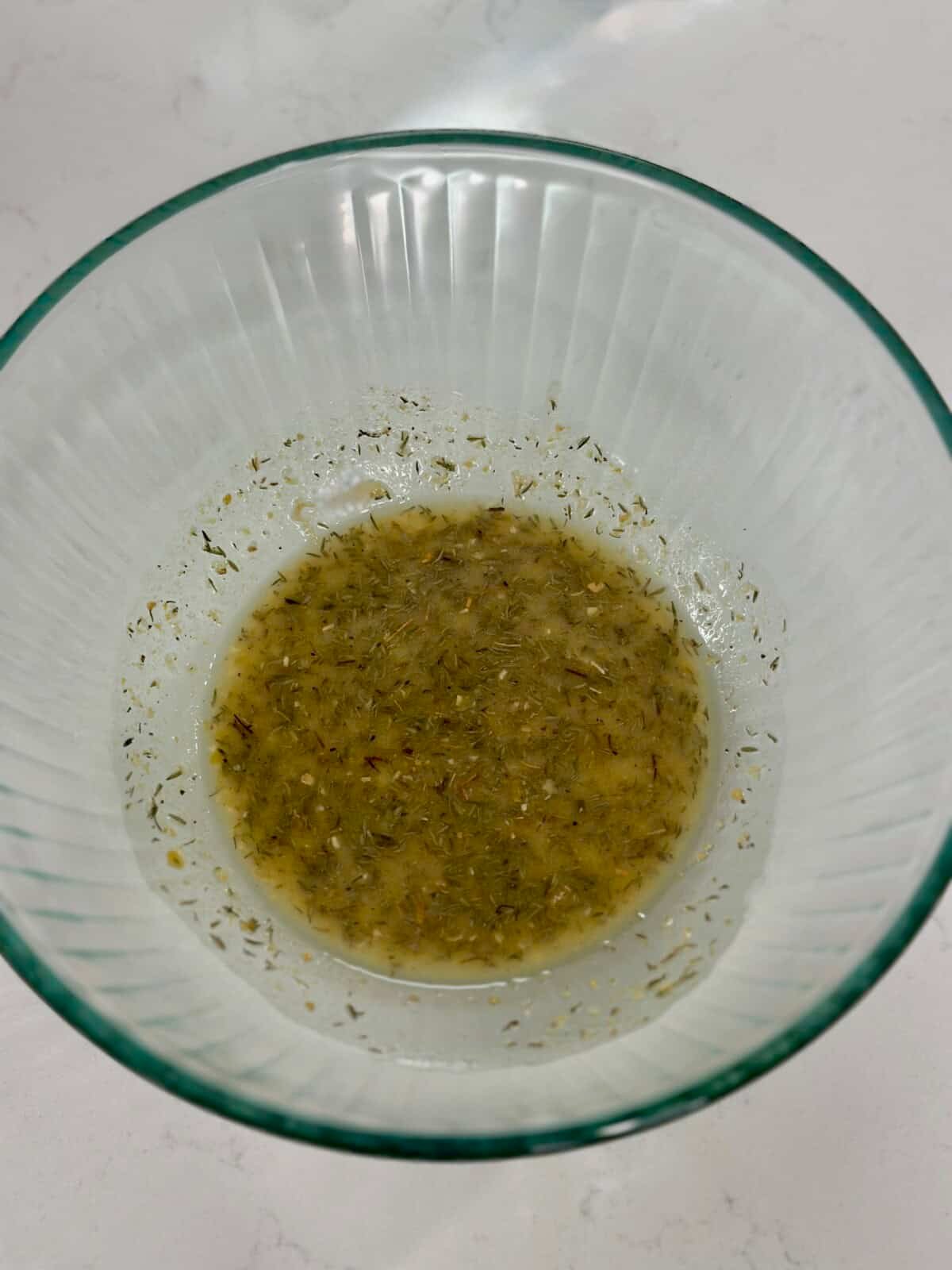 Glass bowl of oil and seasonings