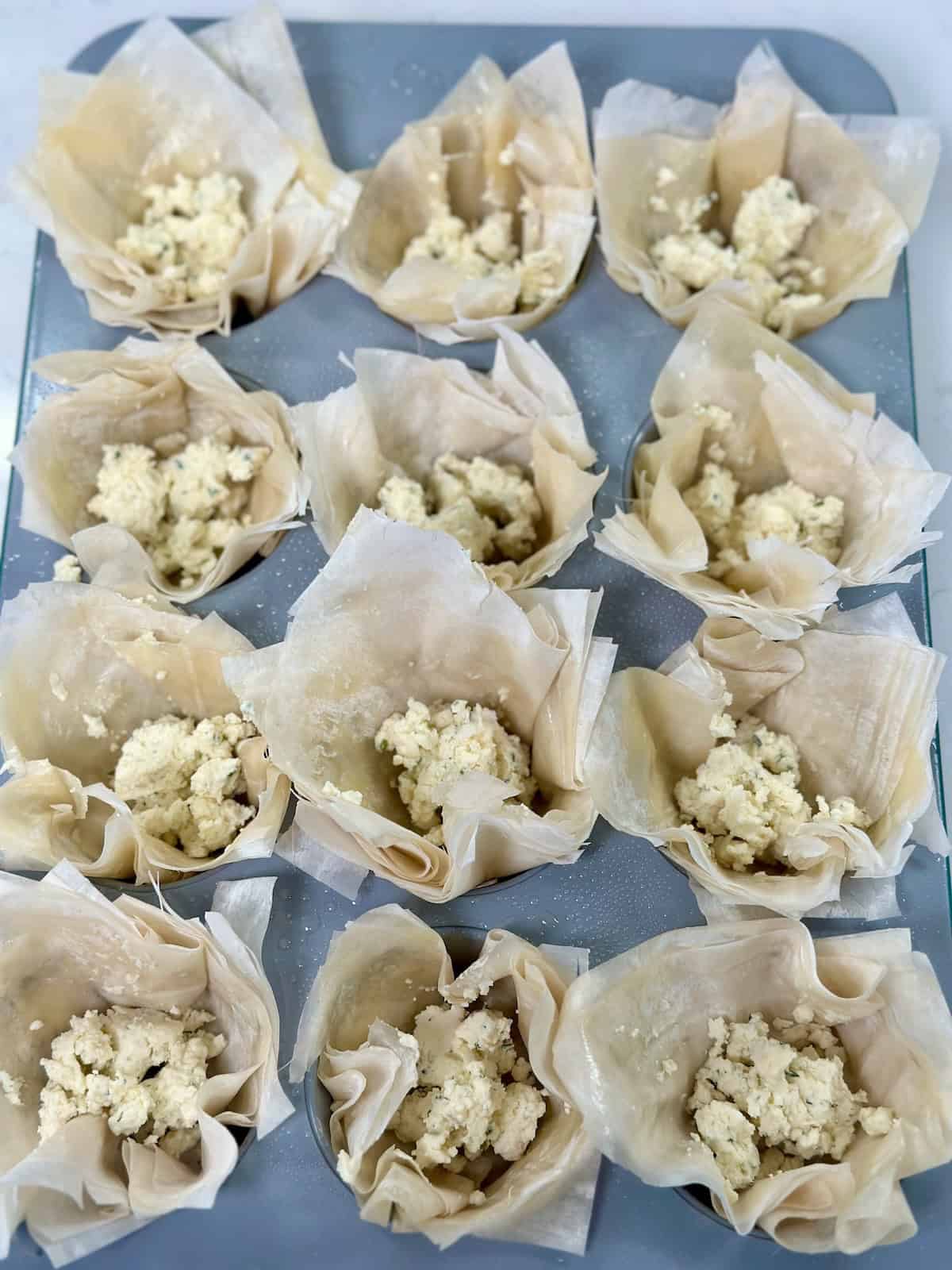 Phyllo cups filled with garlic herb Boursin cheese.