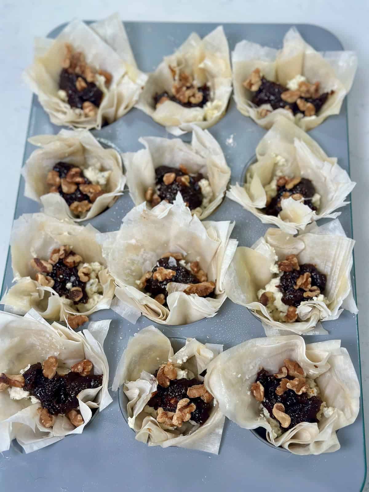 Phyllo cups topped with chopped walnuts for added crunch.