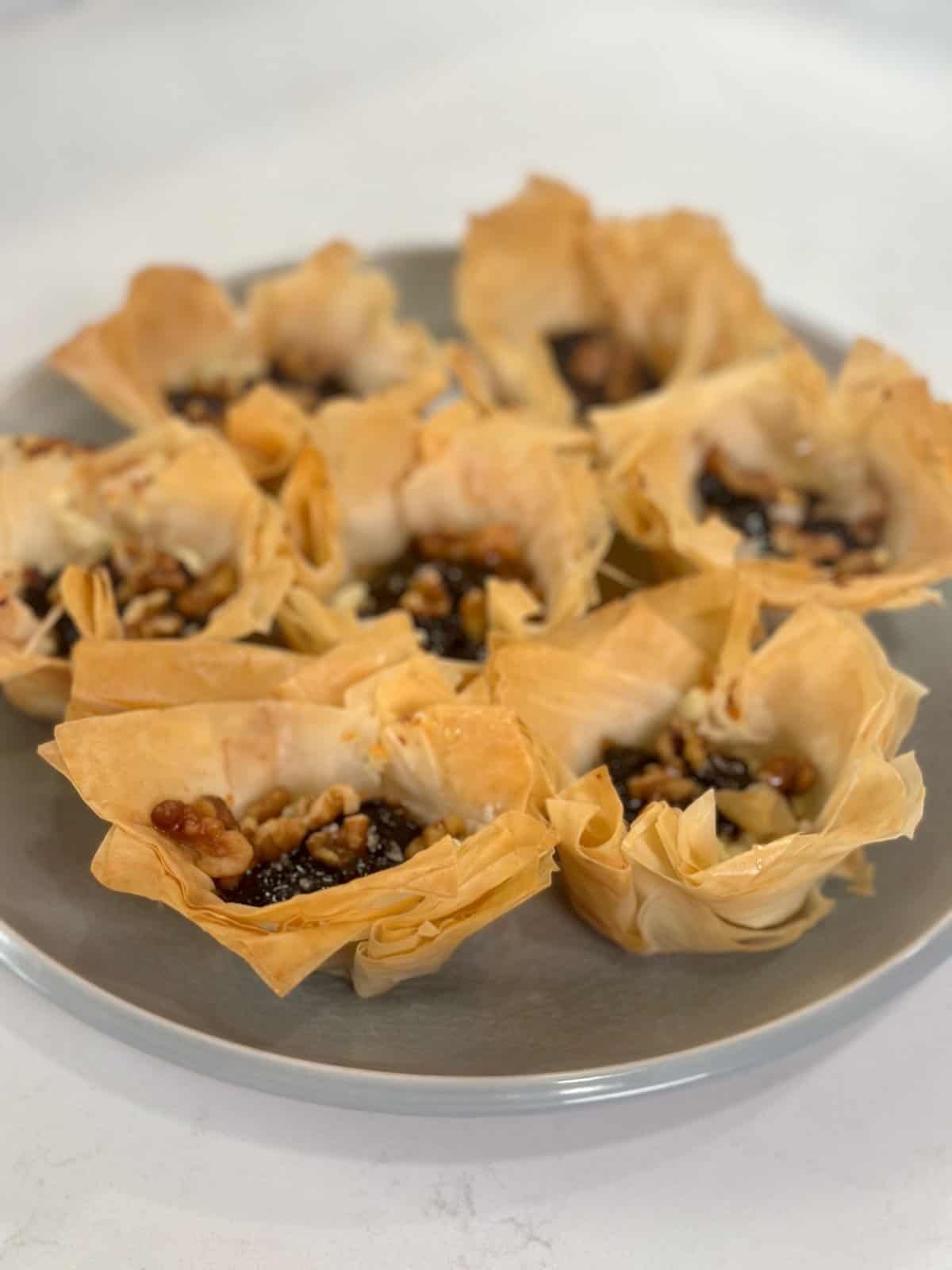 Plate of baked Boursin and fig phyllo cups ready to serve.