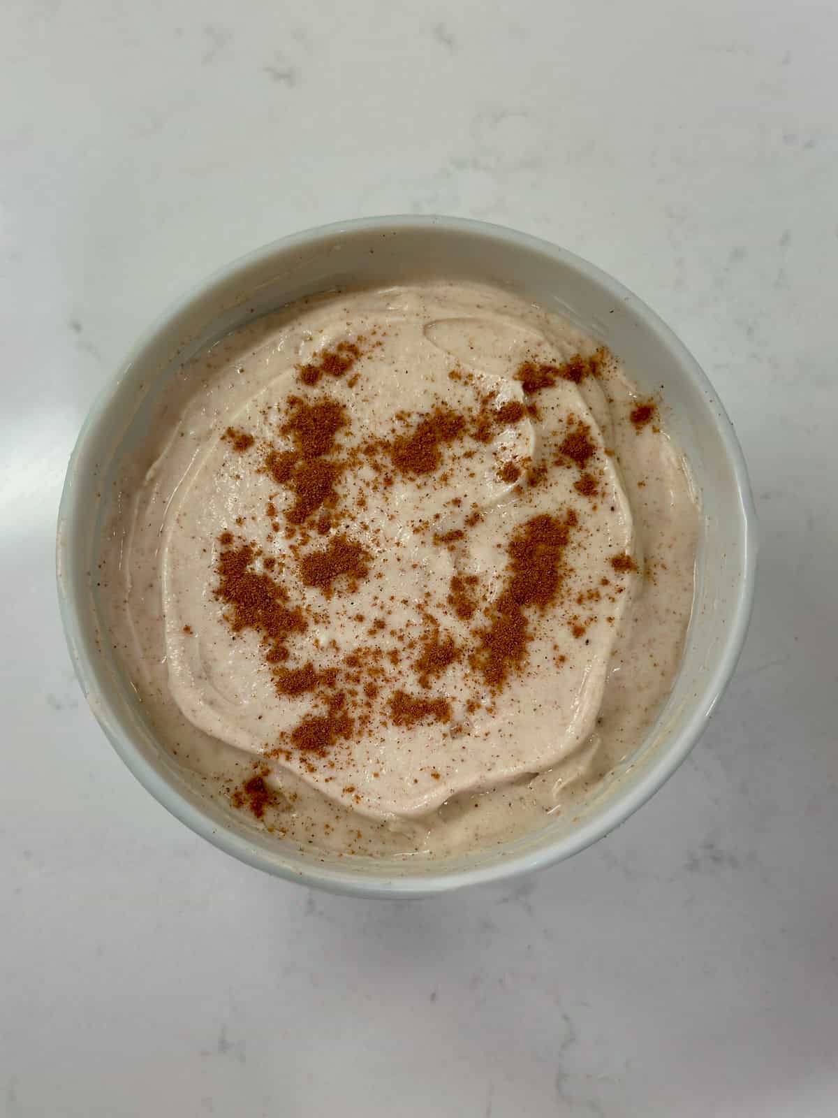 Cream cheese dip topped with a dusting of cinnamon for snickerdoodle flavor.