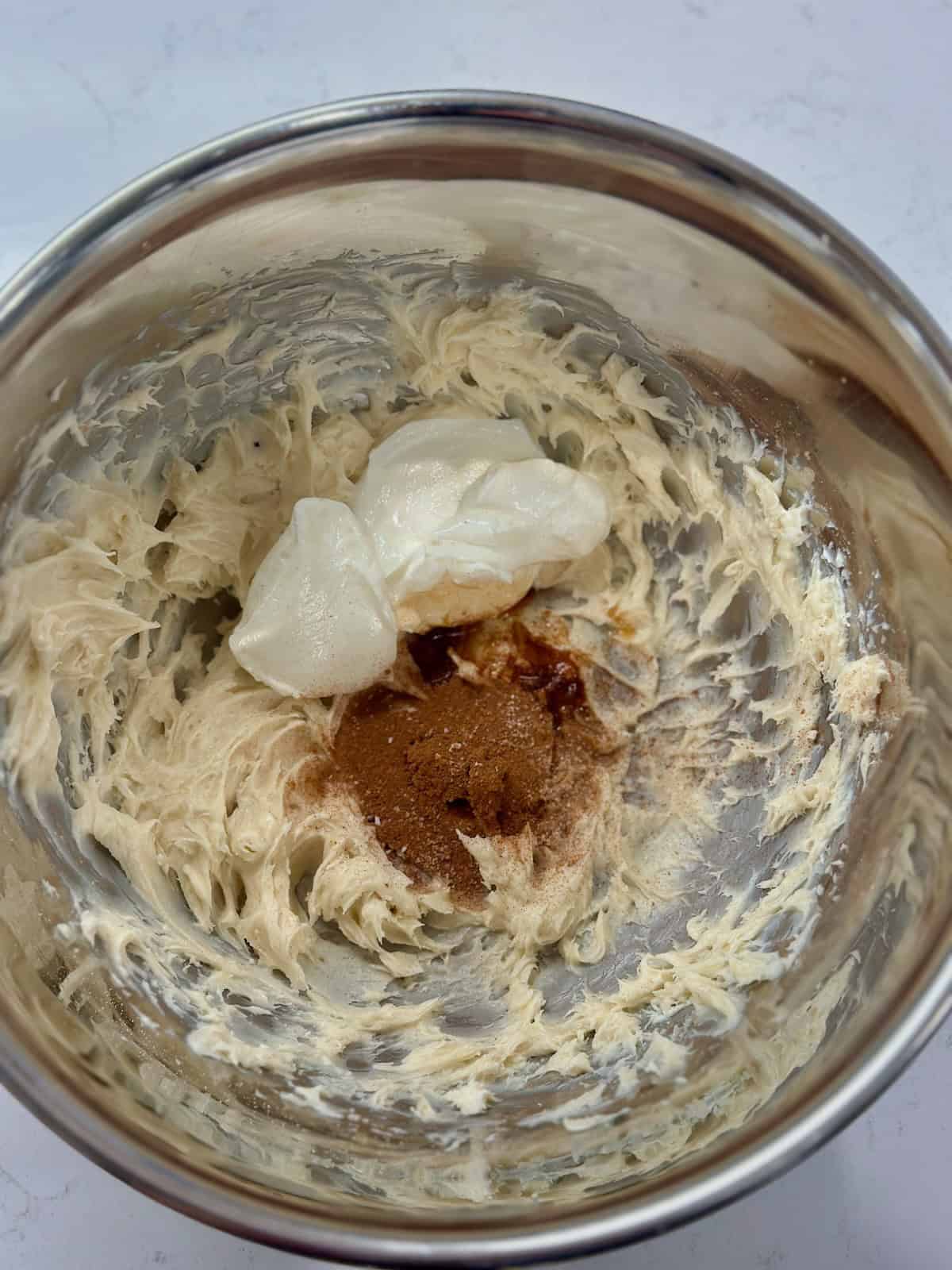 Greek yogurt, vanilla, and cinnamon added to the beaten cream cheese mixture.