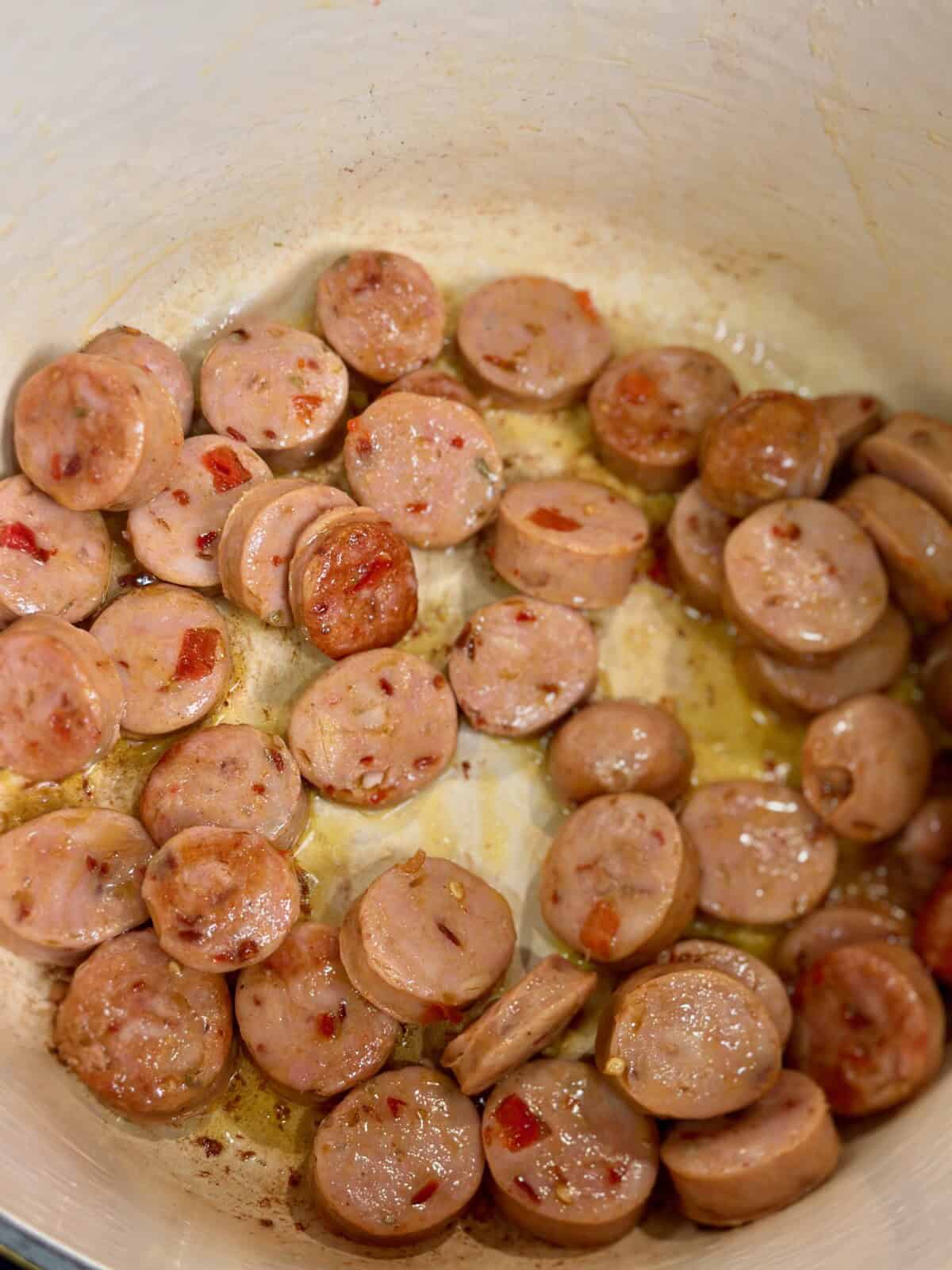 Pot with cooked chicken sausage slices