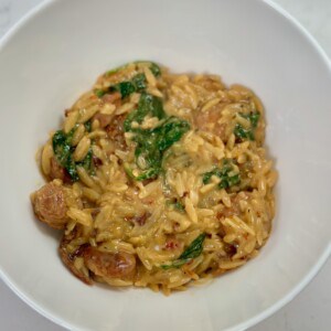 White bowl with One Pot Spicy Italian Sausage Orzo.