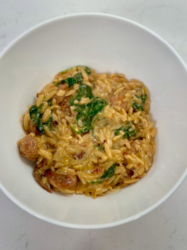 White bowl with One Pot Spicy Italian Sausage Orzo.