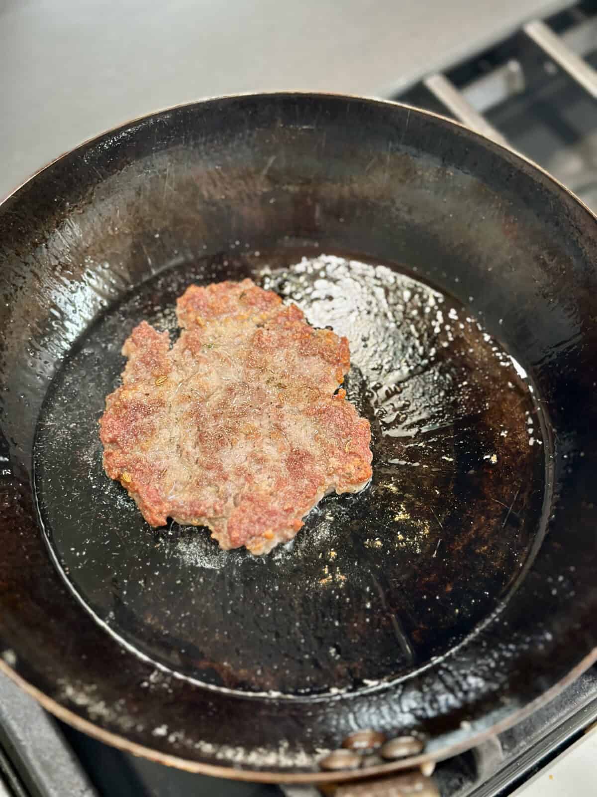 A pan with a sausage patty