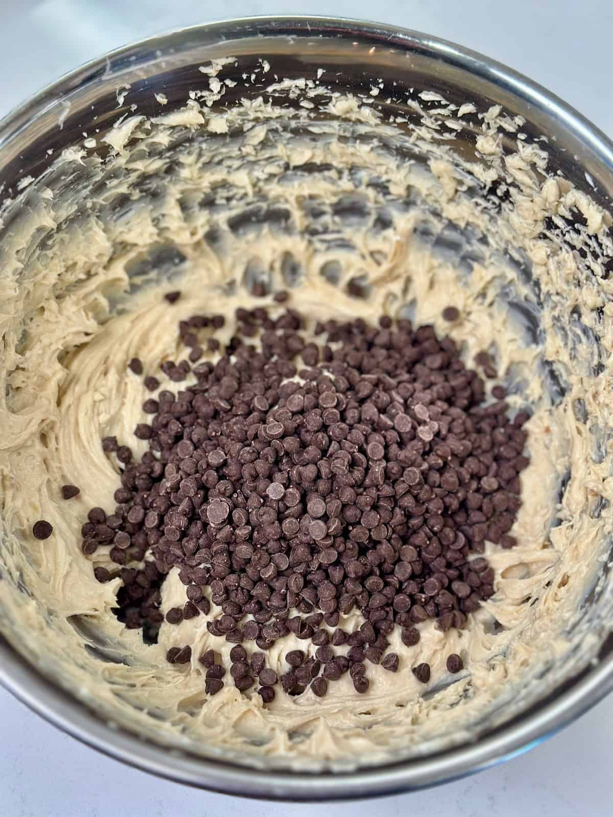 Folding mini chocolate chips into cookie dough dip.