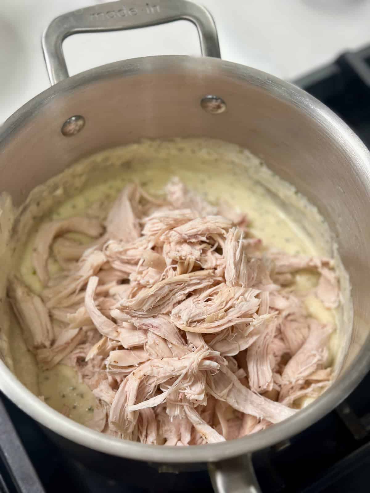 Shredded chicken in alfredo sauce.