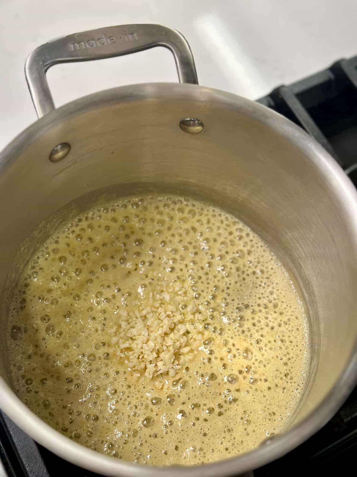 Roux with garlic cooking in a pot.