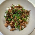 Bowl of rice, instant pot chinese chicken, cilantro, green onions, and chili crisp