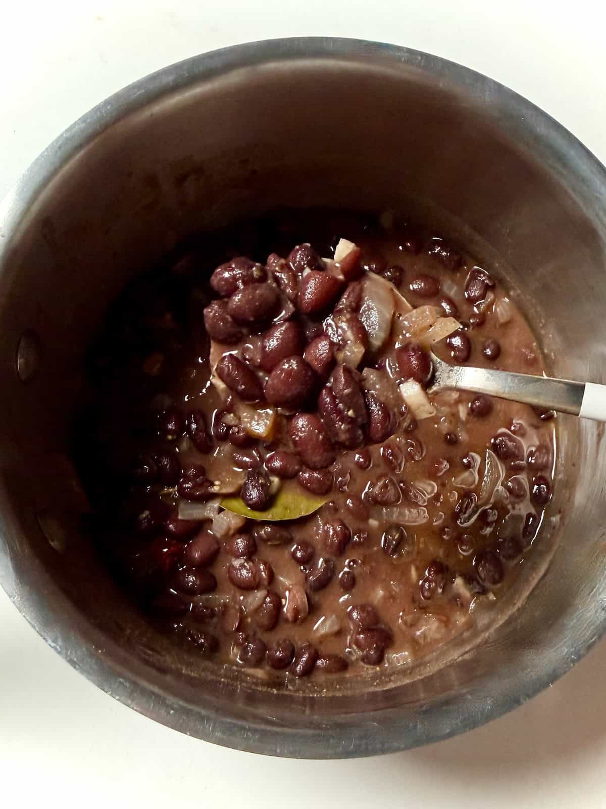 Chipotle copycat black beans on spoon.