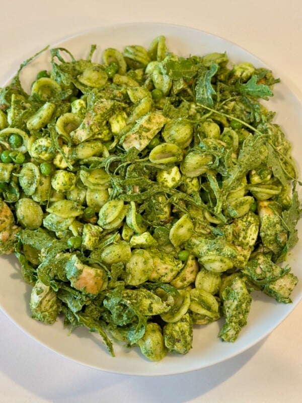 Green Pasta Salad in a white serving bowl