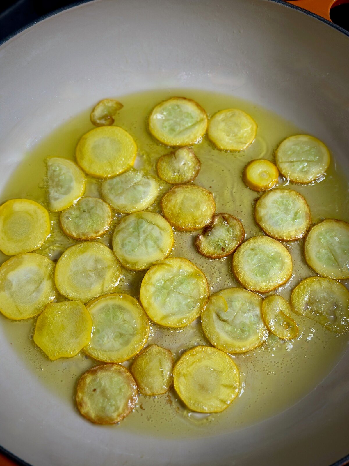 Thinly Sliced Zucchini Frying in Pan
