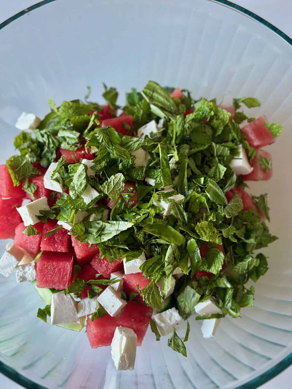 Watermelon, Cucumber, Fresh Herbs, and Feta in Glass Bowl