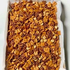 Homemade ranch cheez-it snack mix on a parchment-lined baking sheet.
