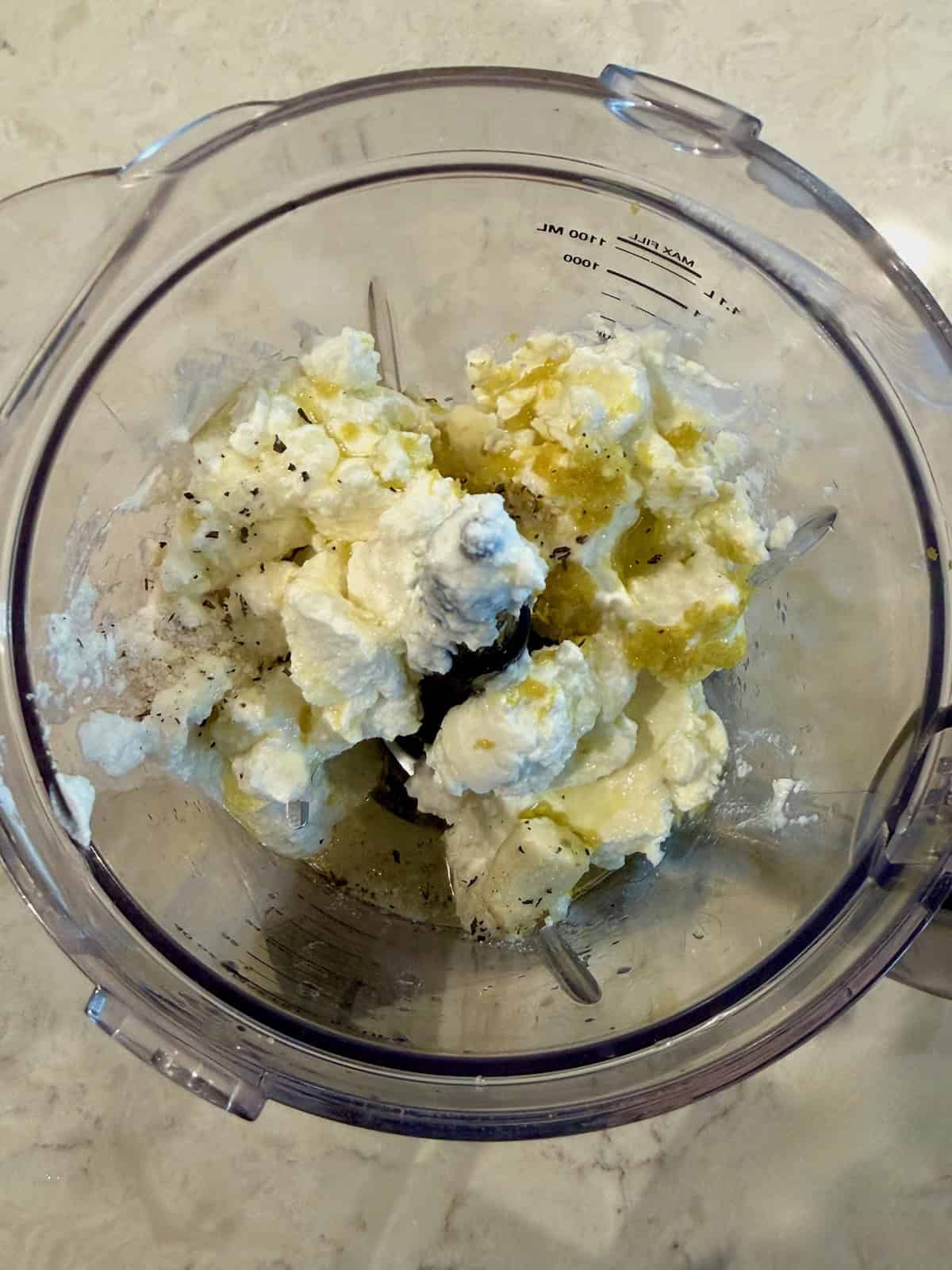 Ricotta, lemon, garlic, olive oil, and salt in a food processor.