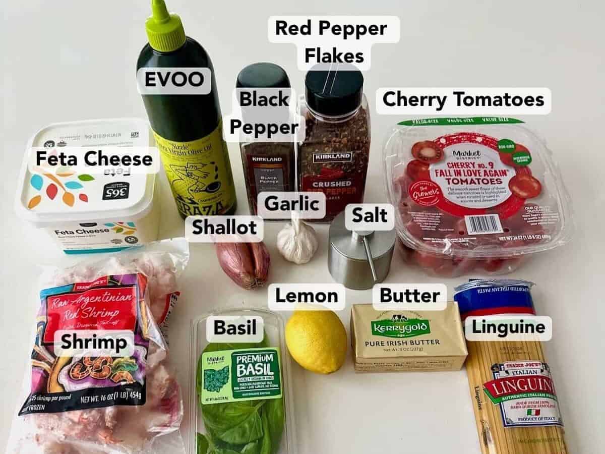 Tomato Basil Shrimp Pasta ingredients including shrimp, linguine, cherry tomatoes, feta cheese, fresh basil, lemon, shallot, garlic, butter, olive oil, salt, black pepper, and red pepper flakes.