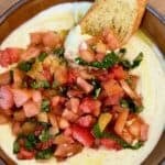 Whipped ricotta bruschetta dip served with crostini.