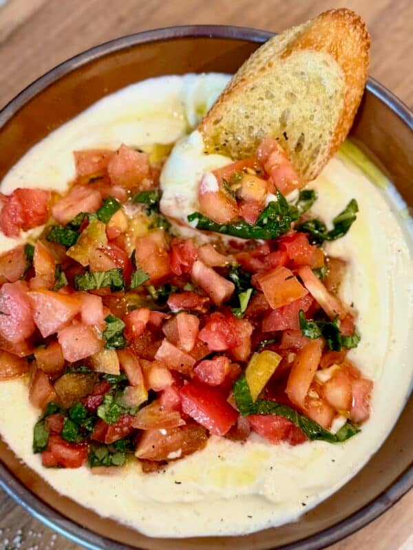 Whipped ricotta bruschetta dip served with crostini.