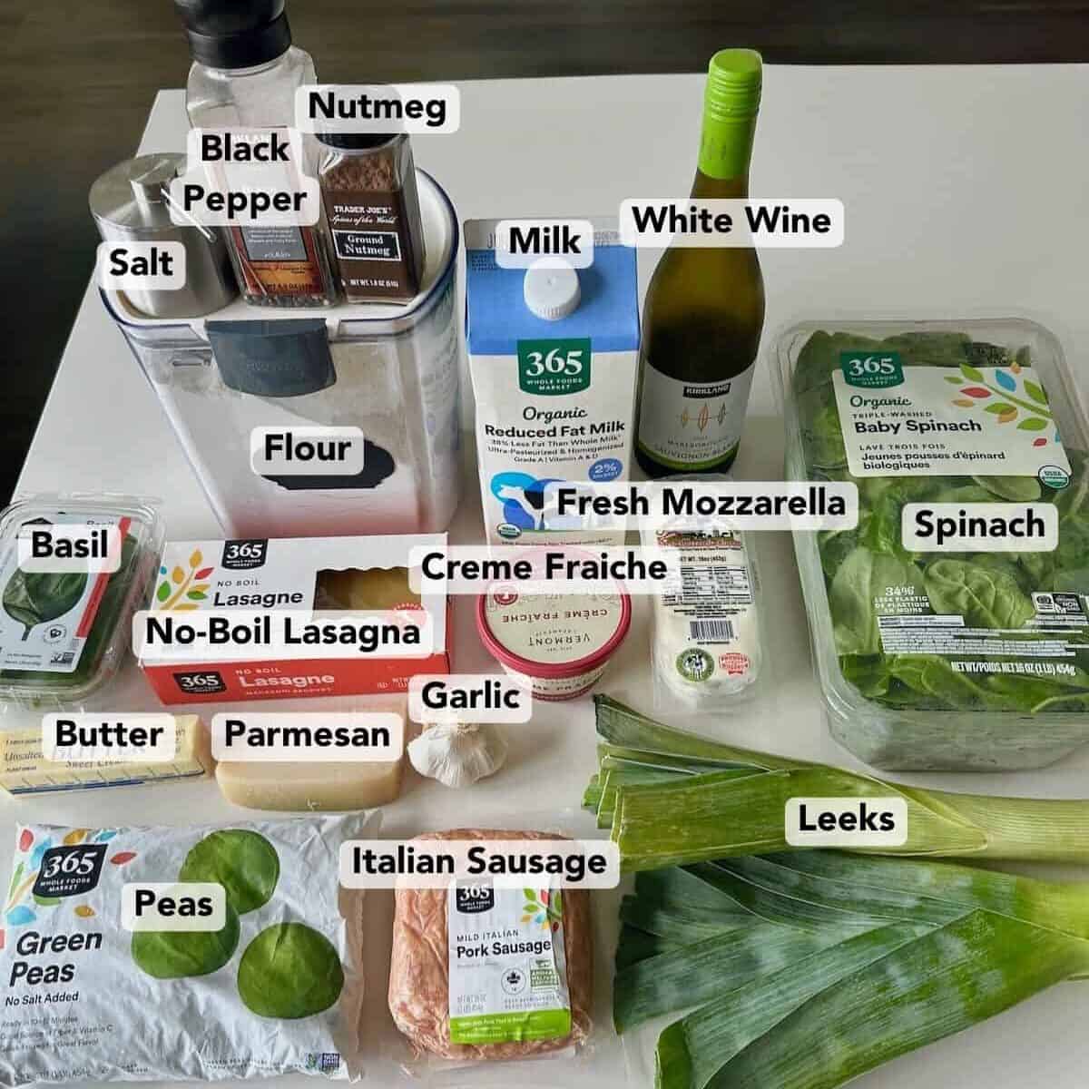 Ingredients for green lasagna on countertop labeled.