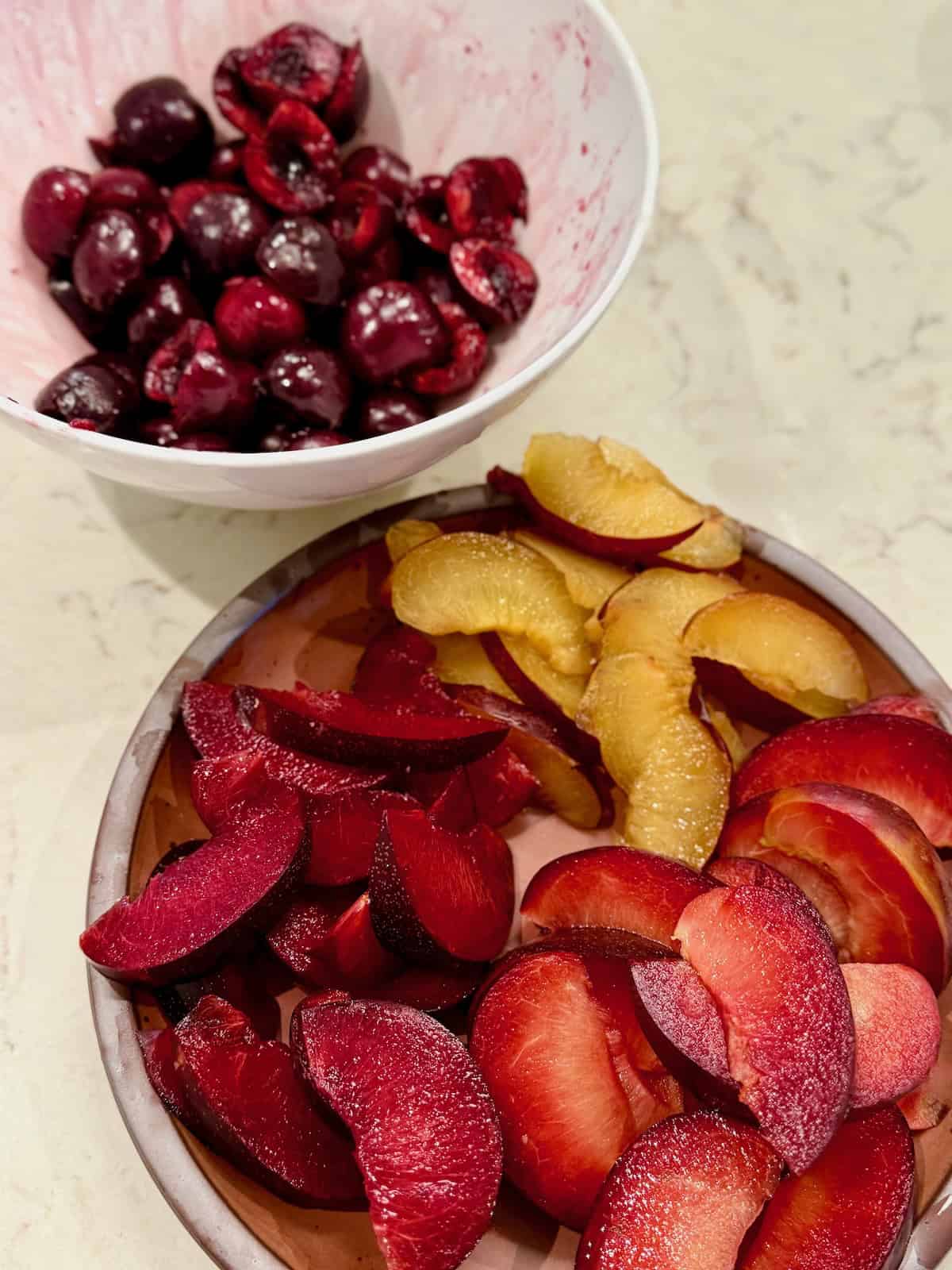Sliced nectarines, red plum, and sweet cherries for stone fruit panzanella salad.