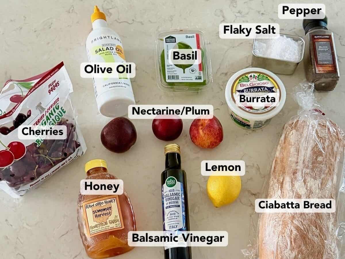 Labeled ingredients for stone fruit panzanella salad with burrata.